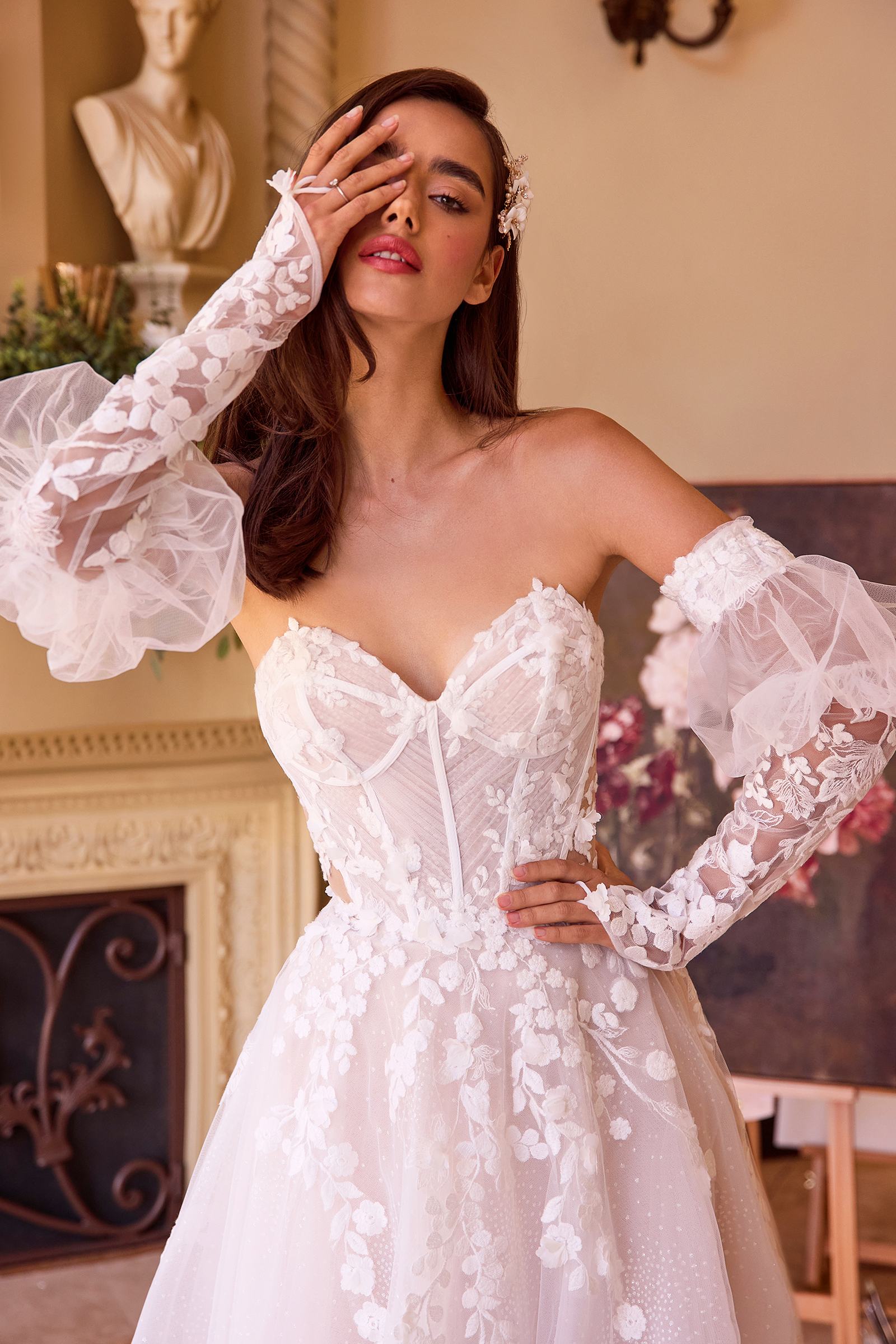 Off-white strapless corset bodice with floral appliques and sheer puff sleeves