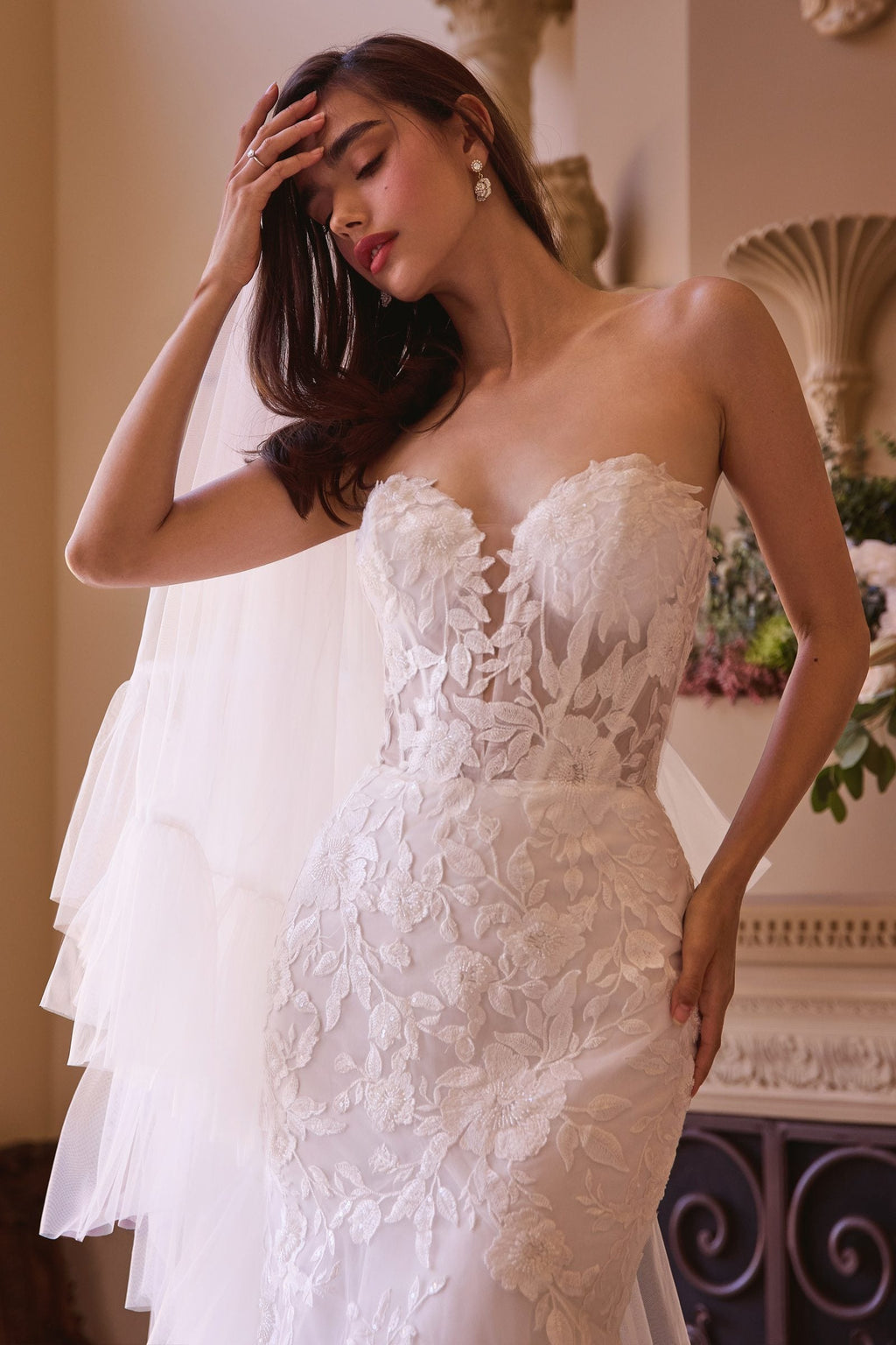 Off-white strapless mermaid bridal gown with lace bodice and layered floral appliqué