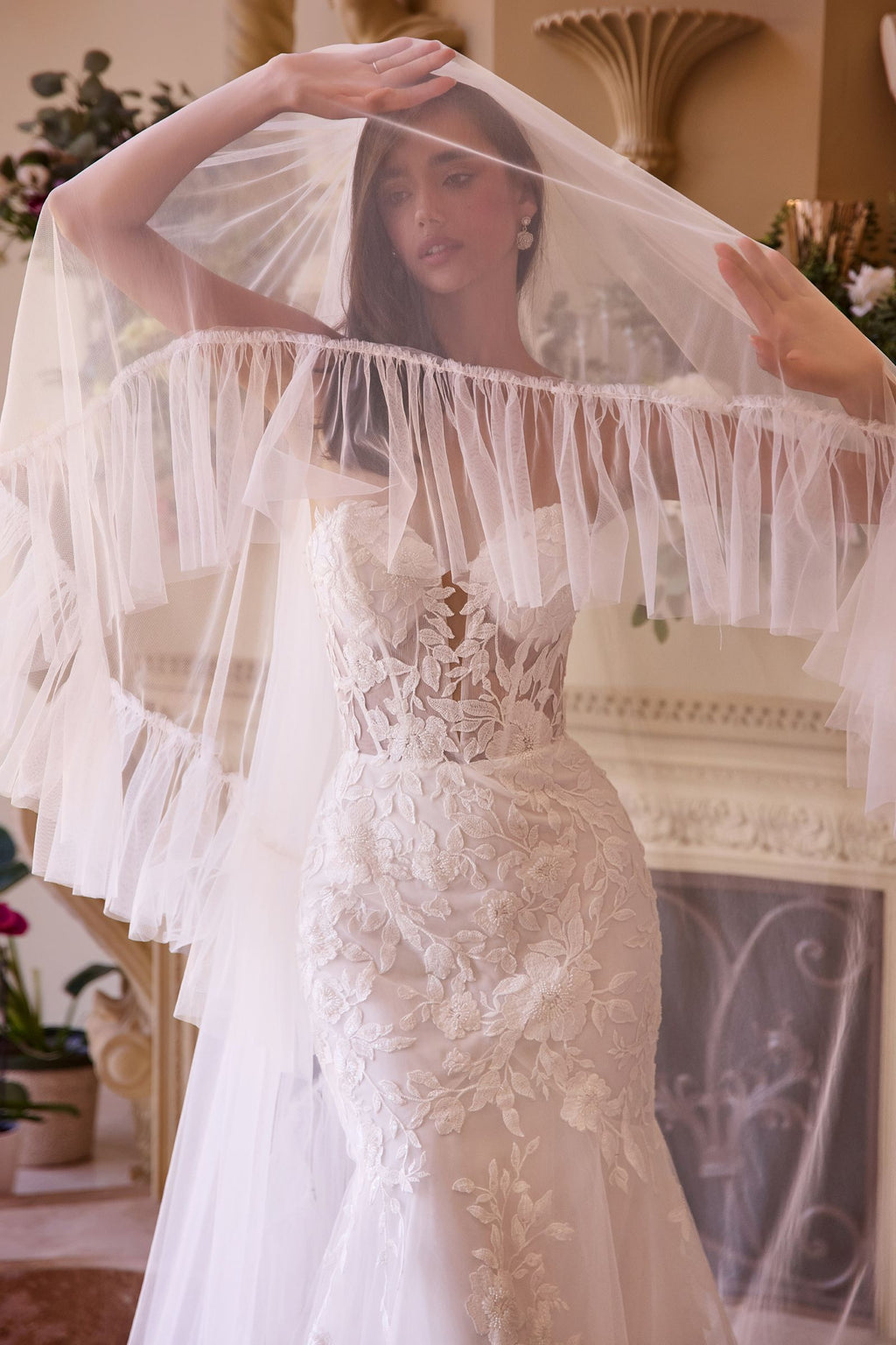 Off-white strapless mermaid bridal gown with lace bodice and sheer tulle sleeve veil