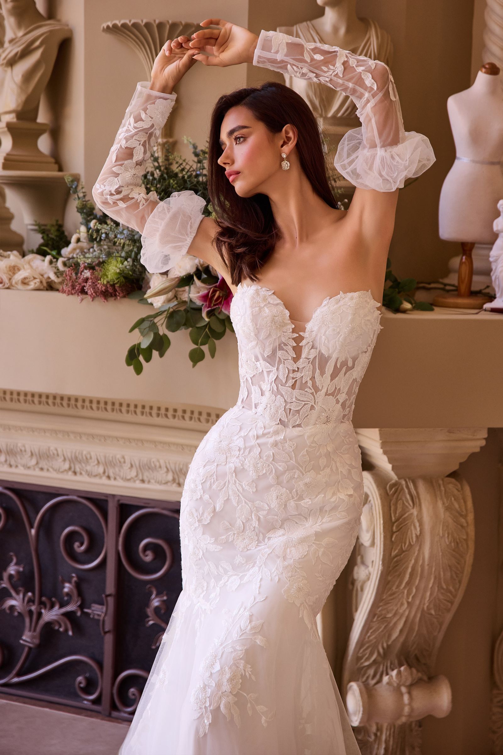 Off-white strapless mermaid bridal gown with lace sleeves and floral chest appliqué