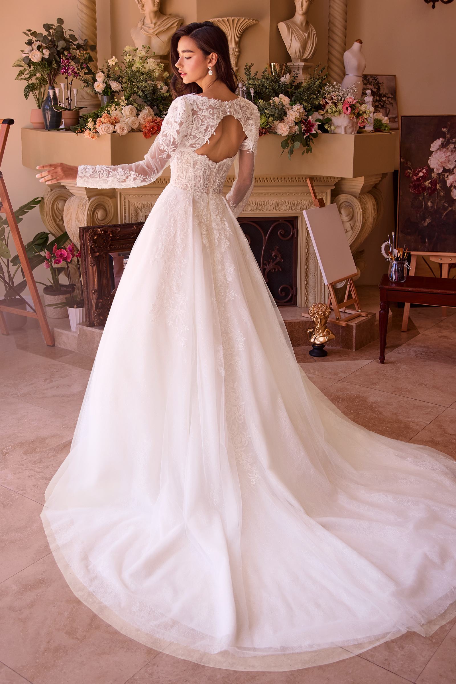 Off-white strapless lace wedding ball gown with full flowing skirt from a side view