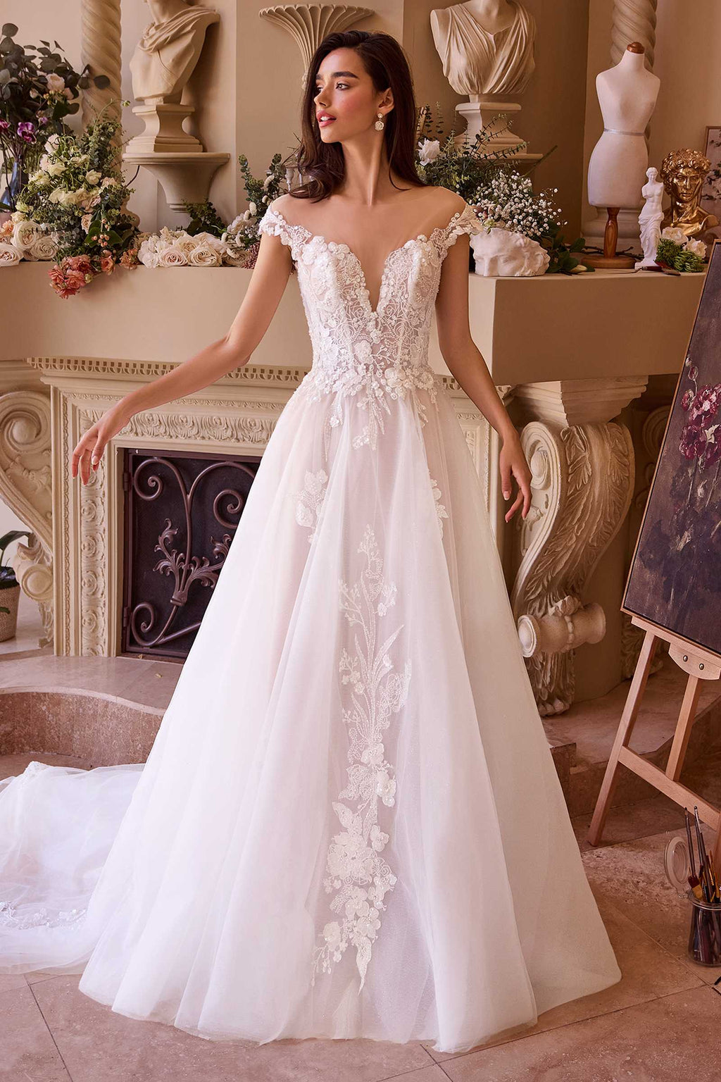 Off-white long lace bridal gown with cap sleeves, fitted bodice, flowing tulle skirt