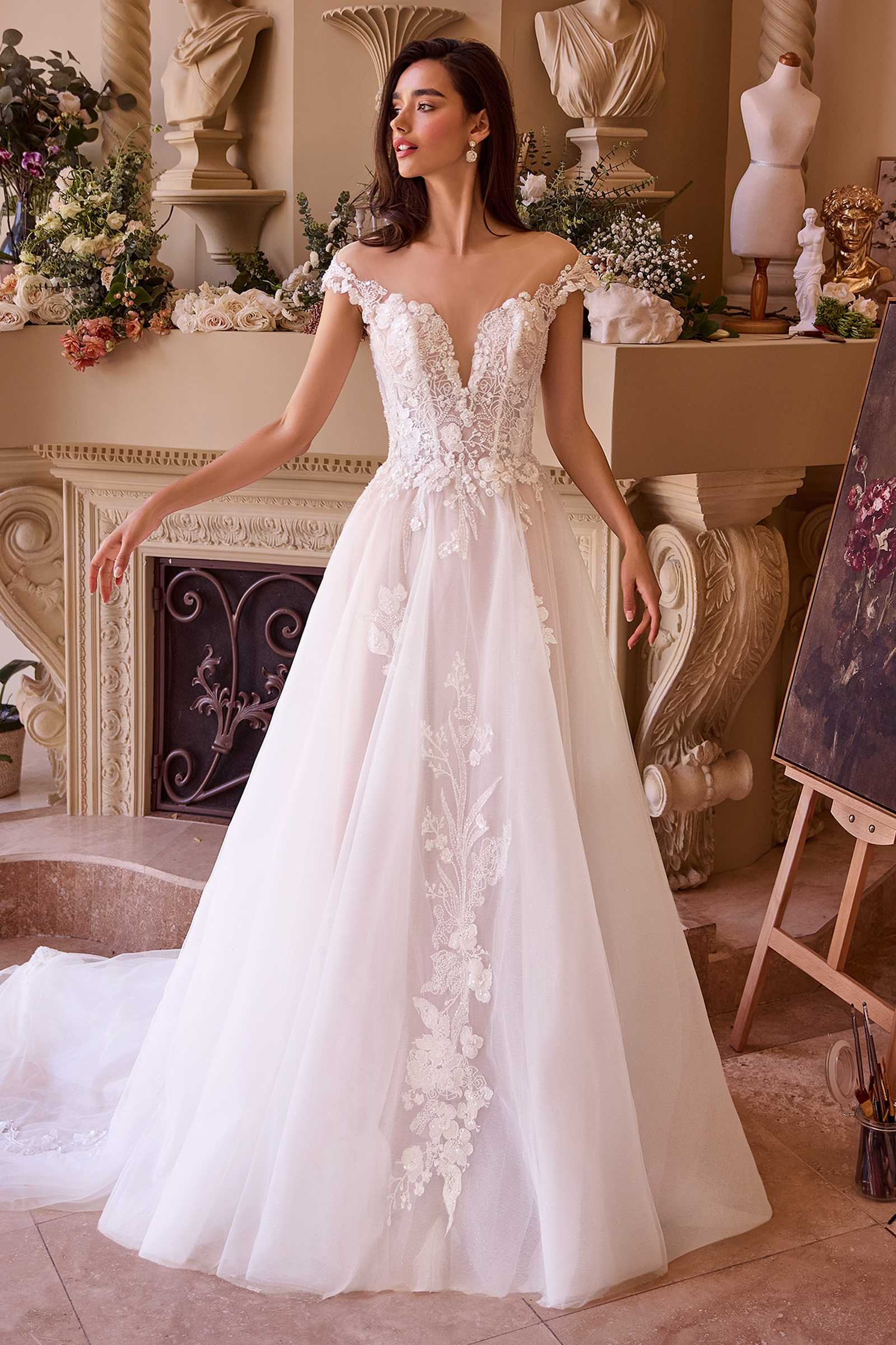 Off-white long lace bridal gown with cap sleeves, fitted bodice, flowing tulle skirt