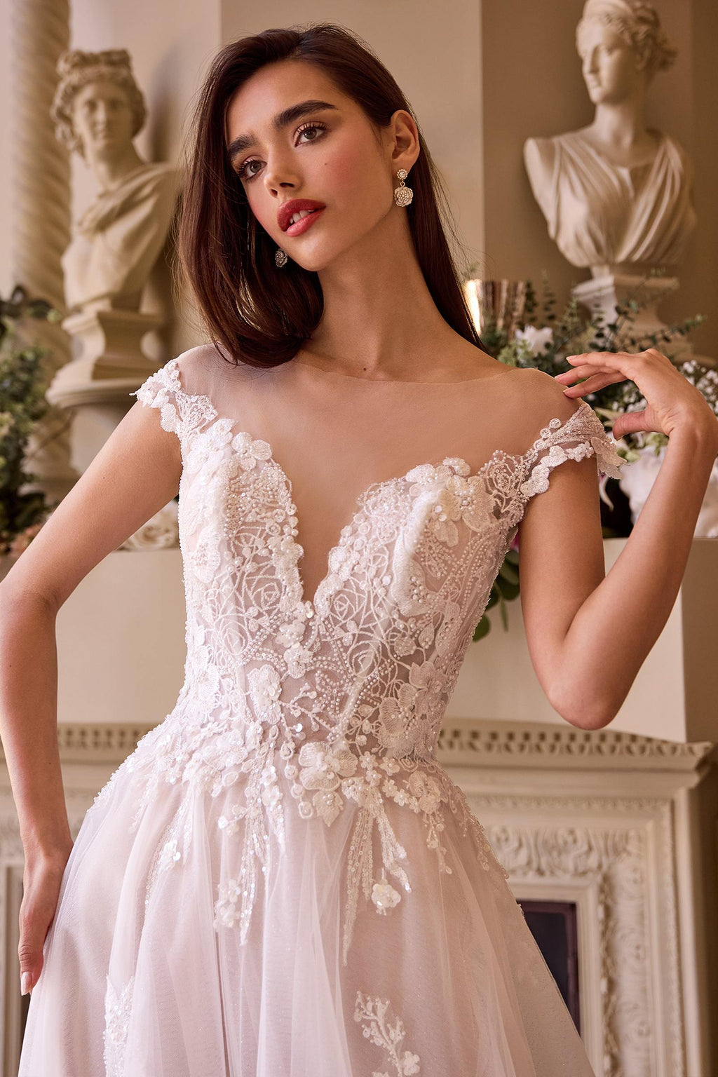 Close-up of off-white lace bridal gown bodice with cap sleeves