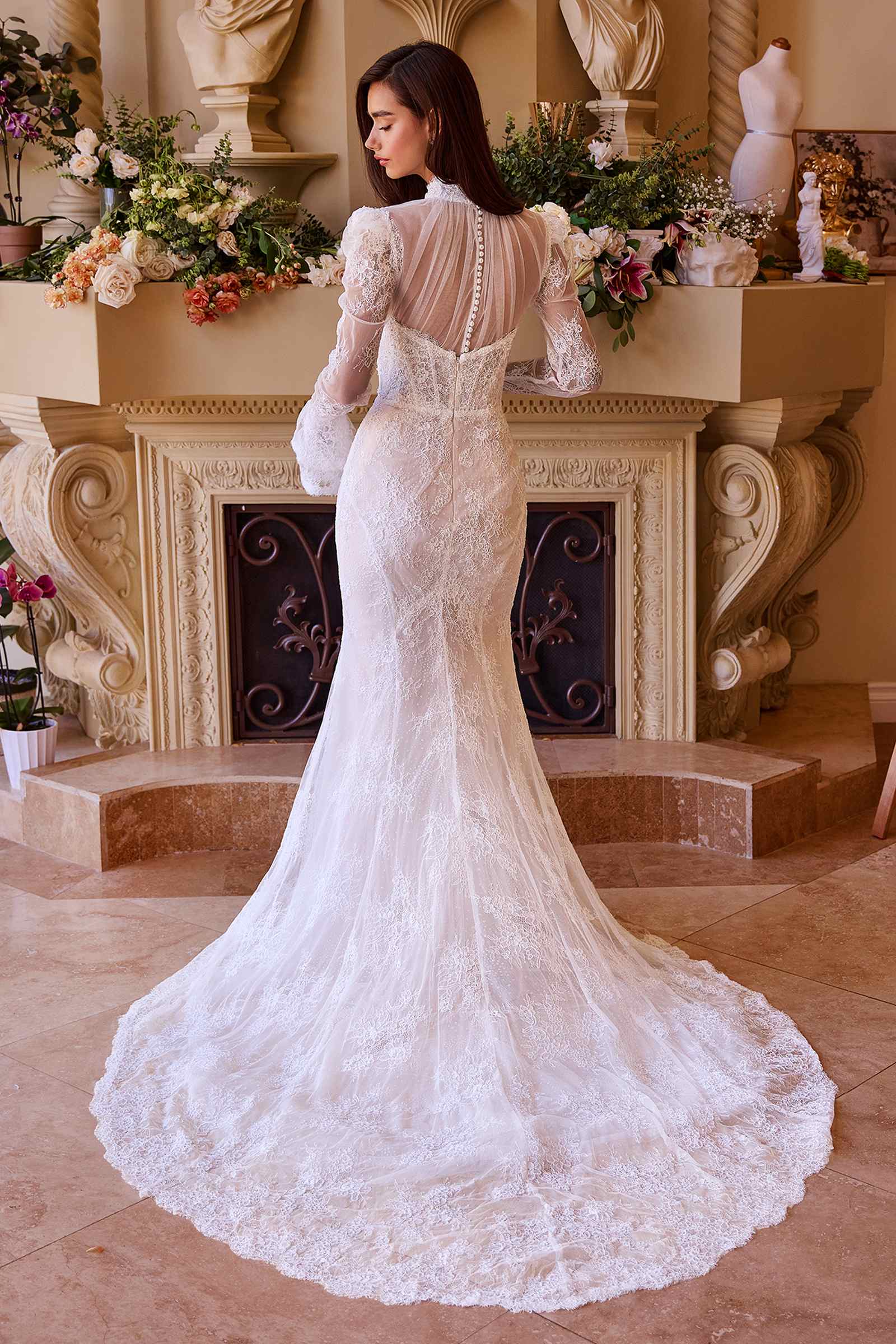Back view of fitted lace bridal dress in off-white with long sleeves and train