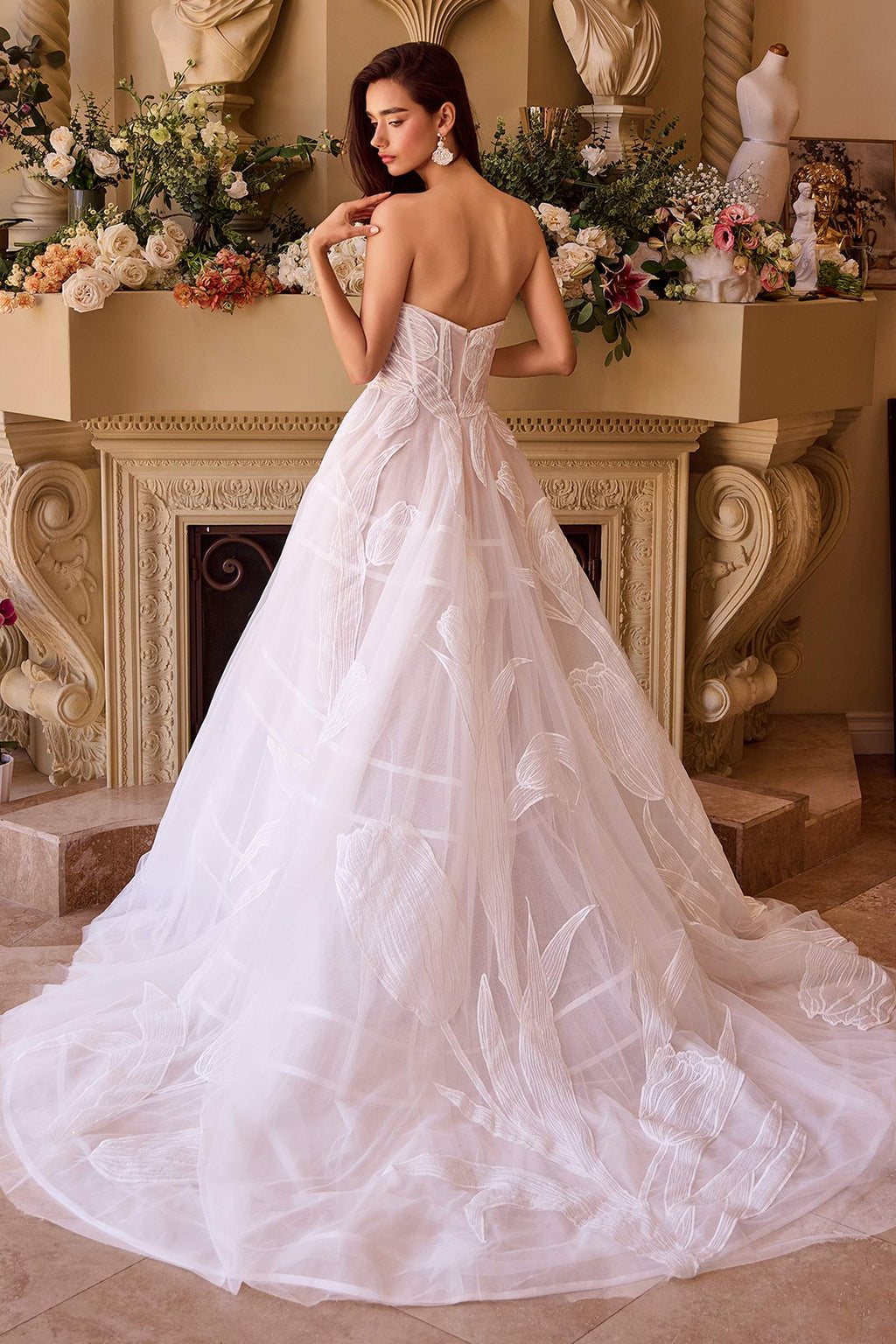 Off-white tulle ball gown with sweetheart neckline, corset bodice, and voluminous layered skirt