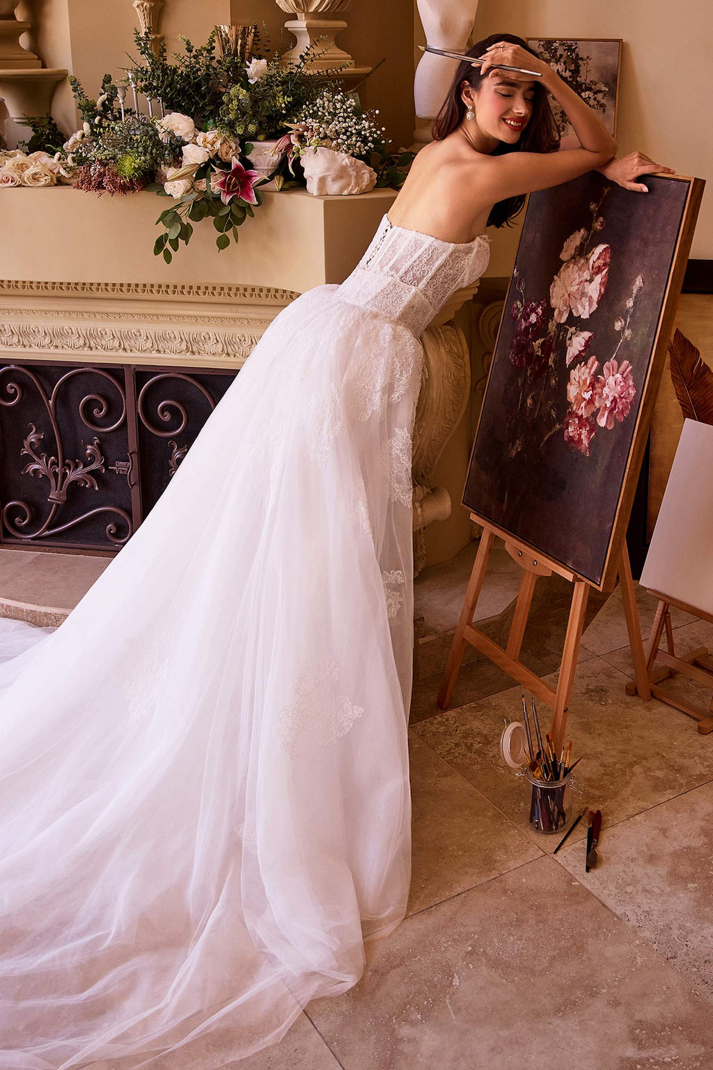 Off-white strapless fitted lace wedding dress with flowing tulle overskirt