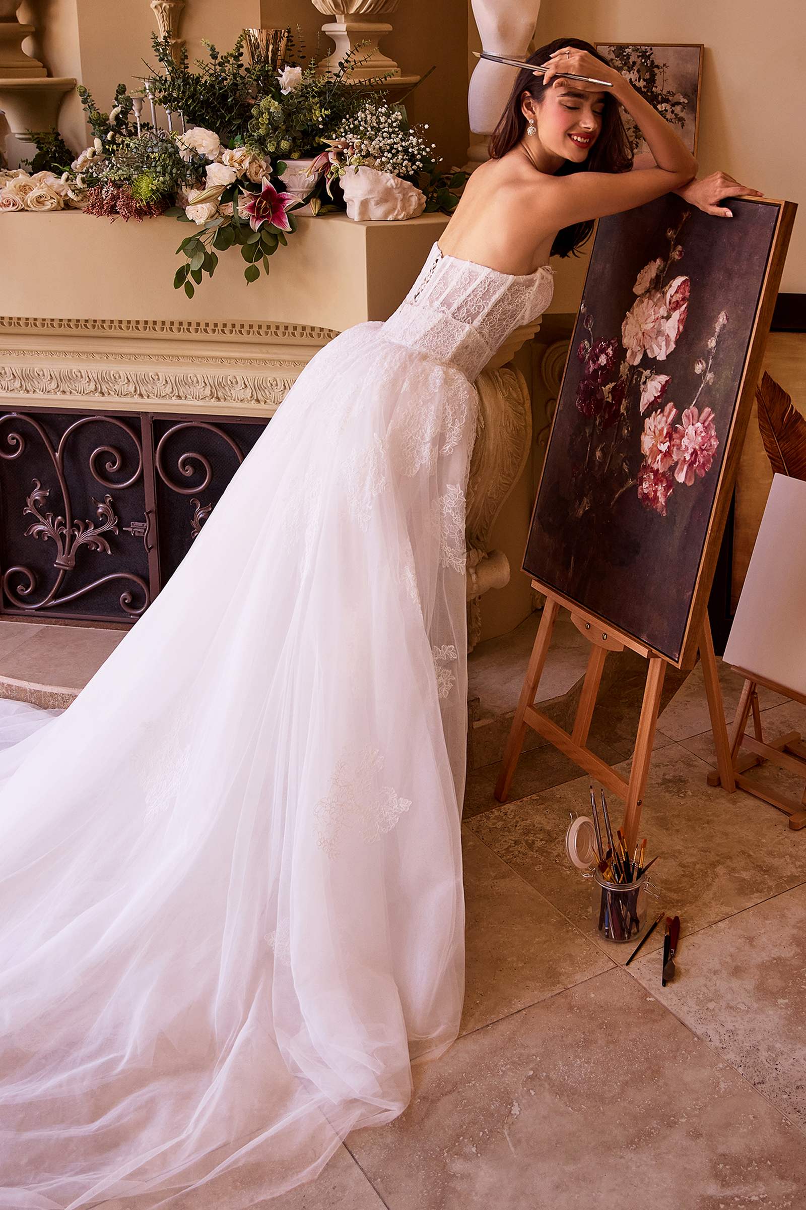 Off-white strapless fitted lace wedding dress with flowing tulle overskirt