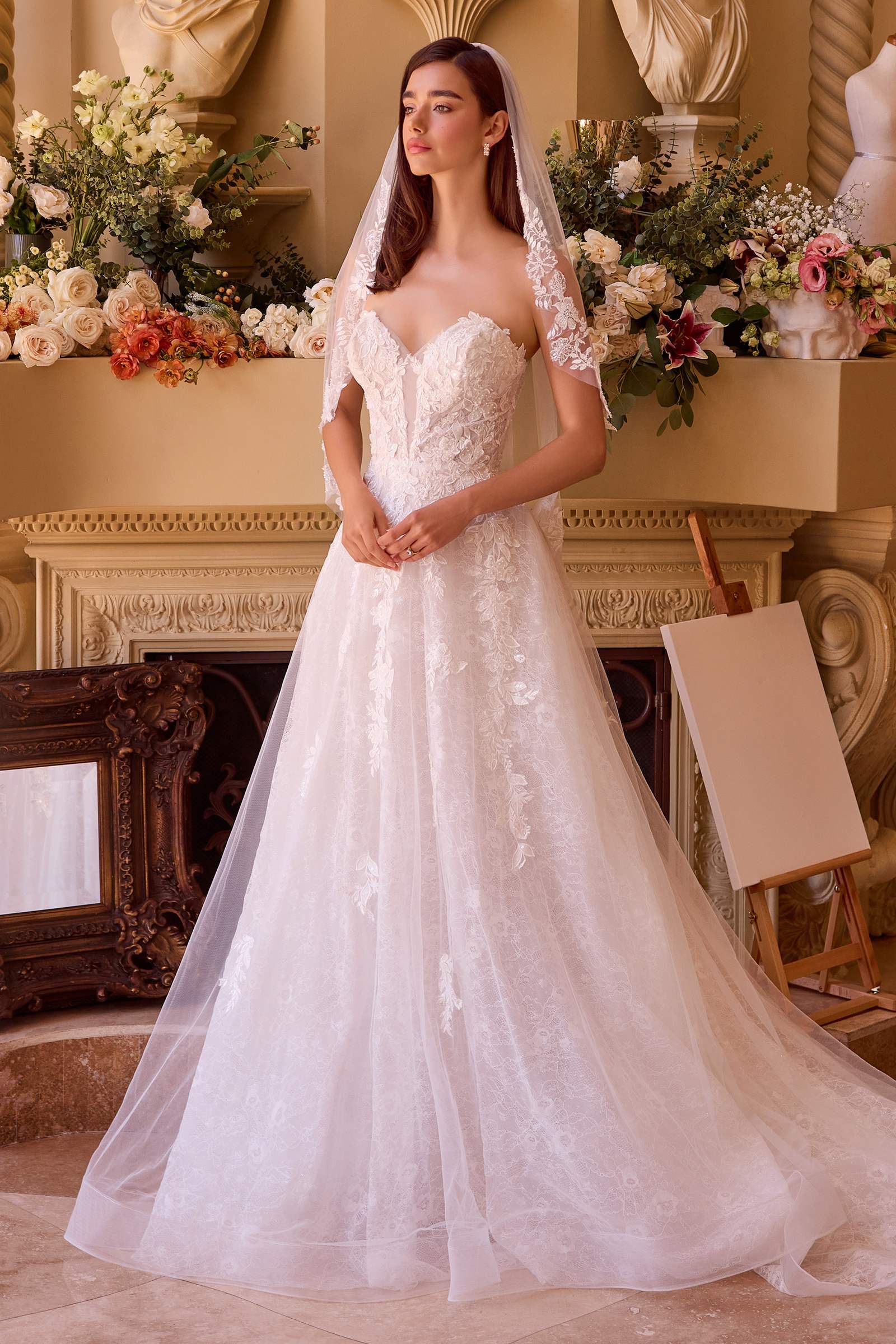 Off-white ball gown with lace bodice, illusion lace sleeves, and full tulle skirt