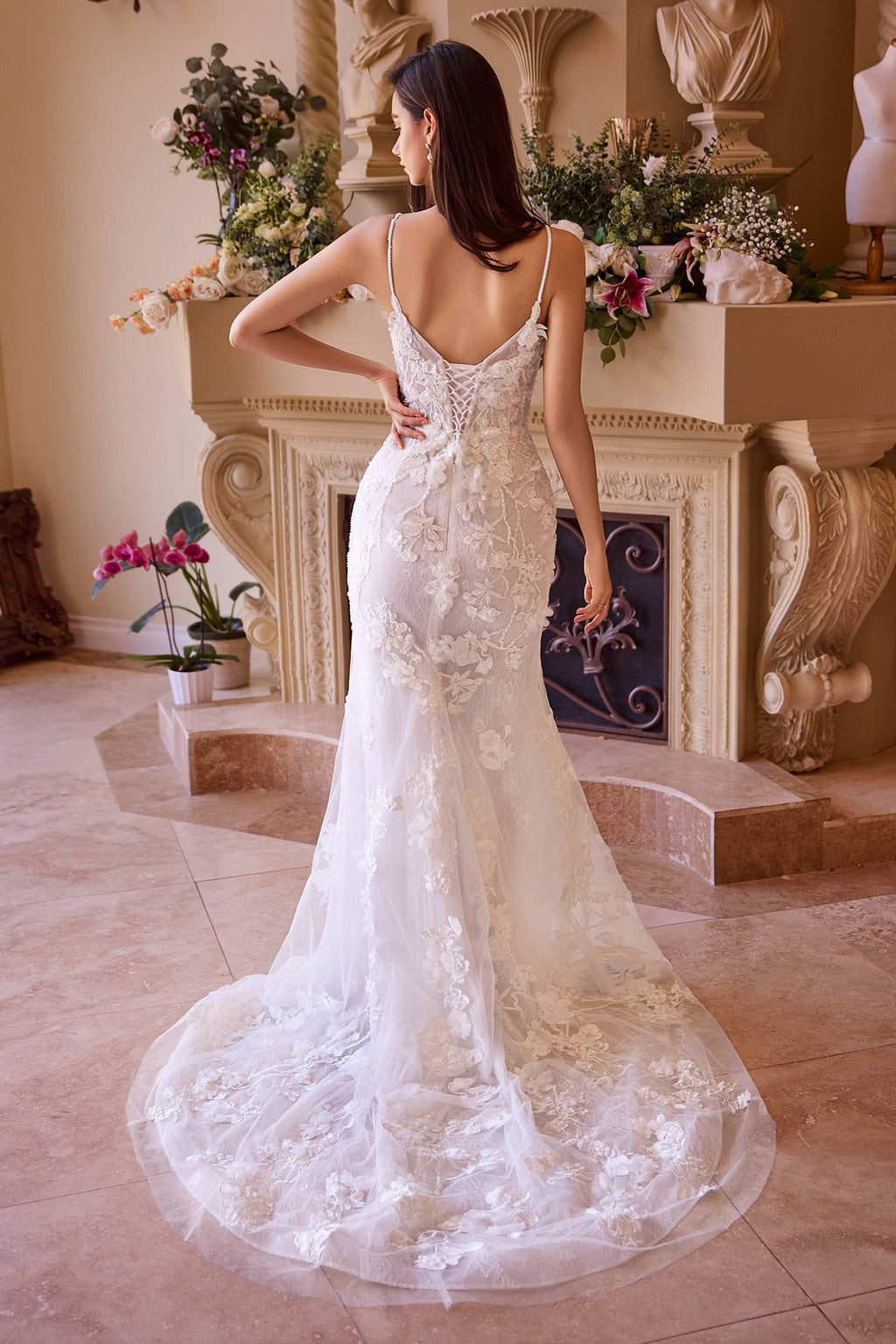 Off-white fitted lace wedding gown with open back and layered mermaid skirt
