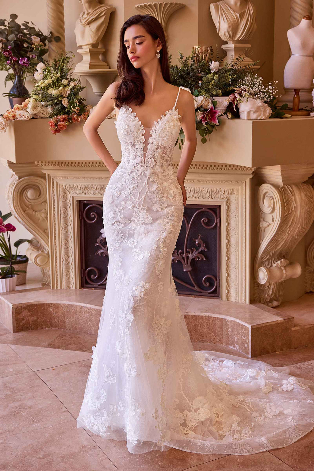 Off-white fitted lace wedding gown with sleeveless V-neck and floral appliqué bodice