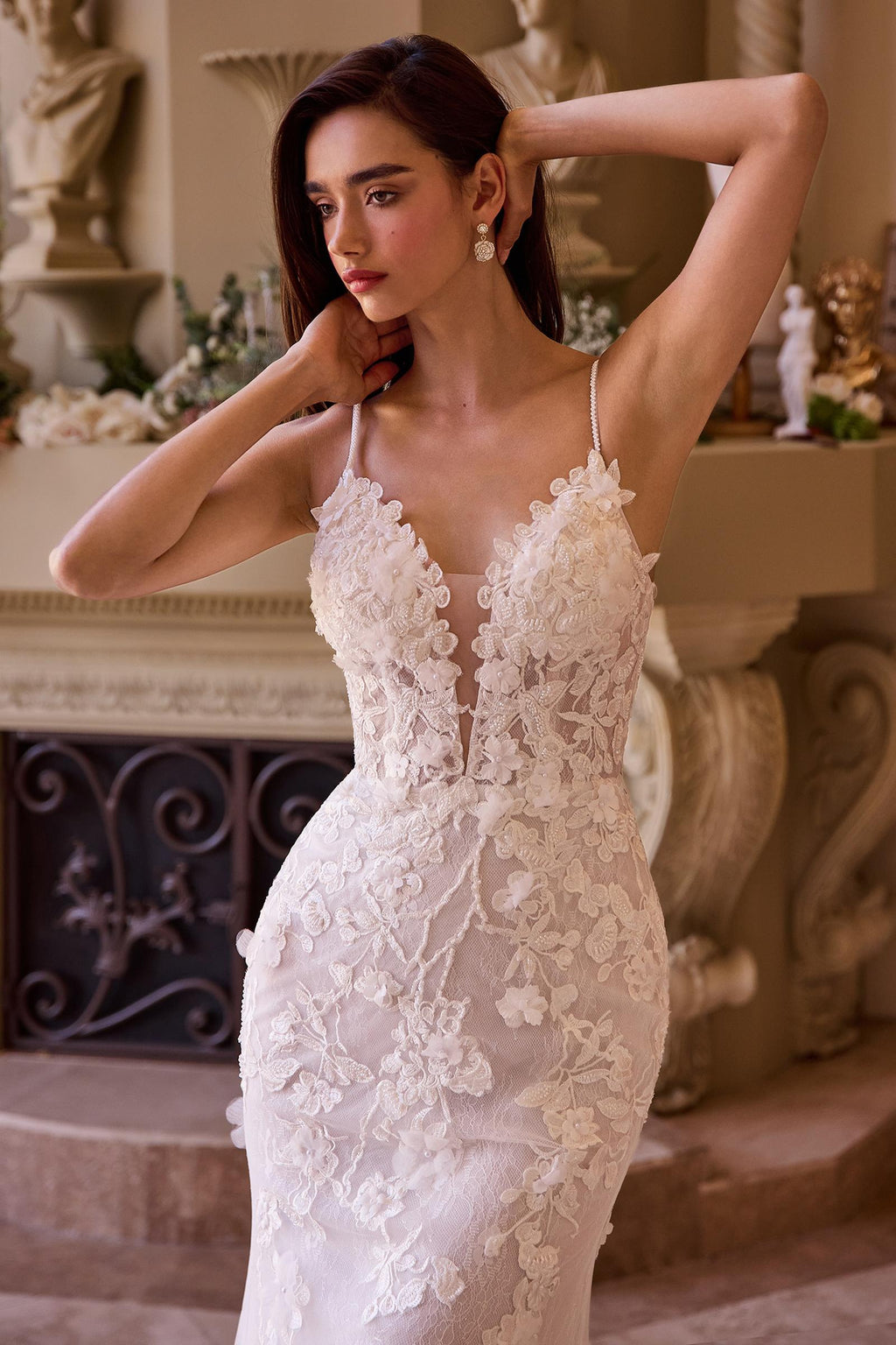 Off-white fitted lace wedding gown with spaghetti straps and floral lace detailing
