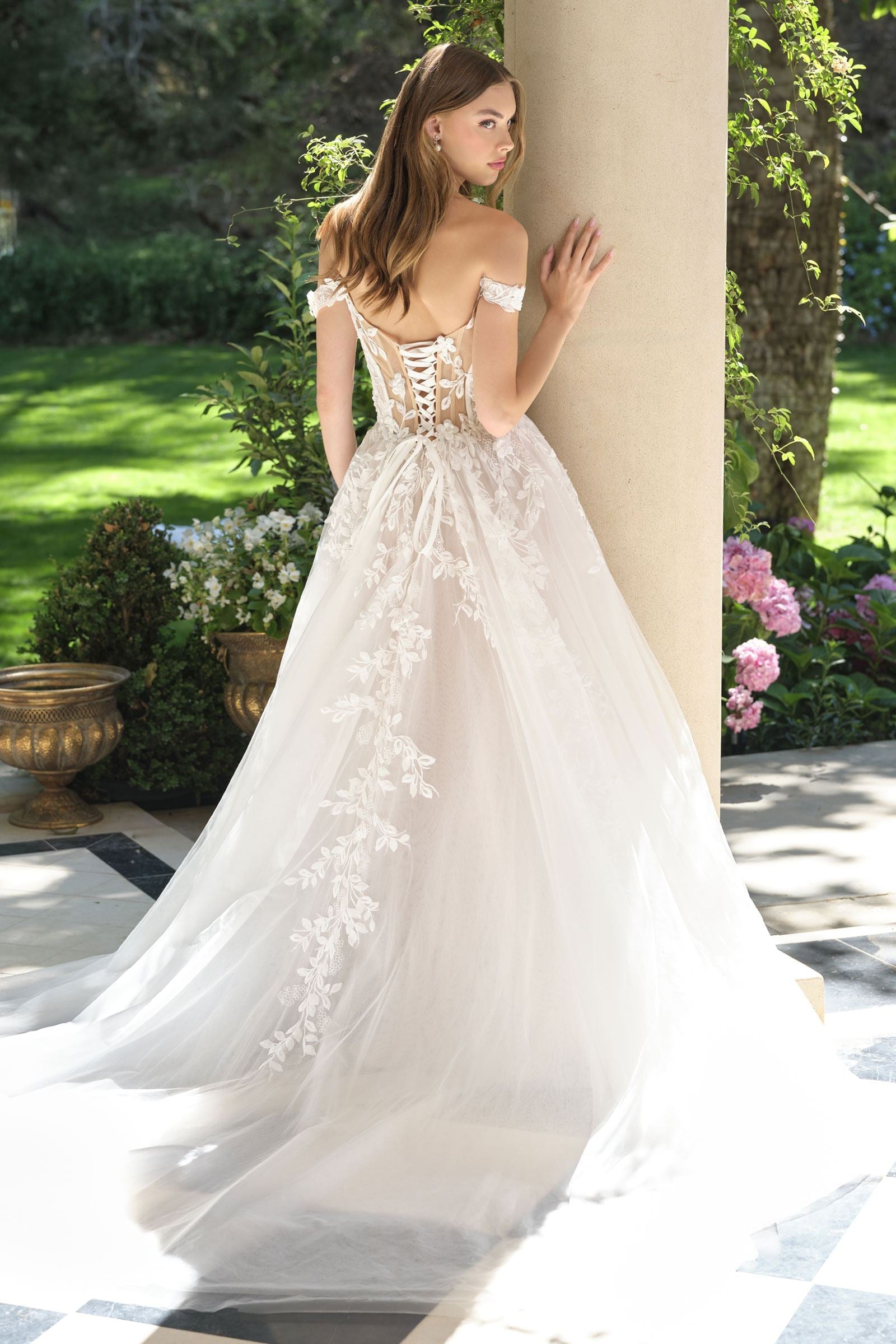 Off-white wedding A-line gown with off-shoulder lace bodice and flowing tulle skirt