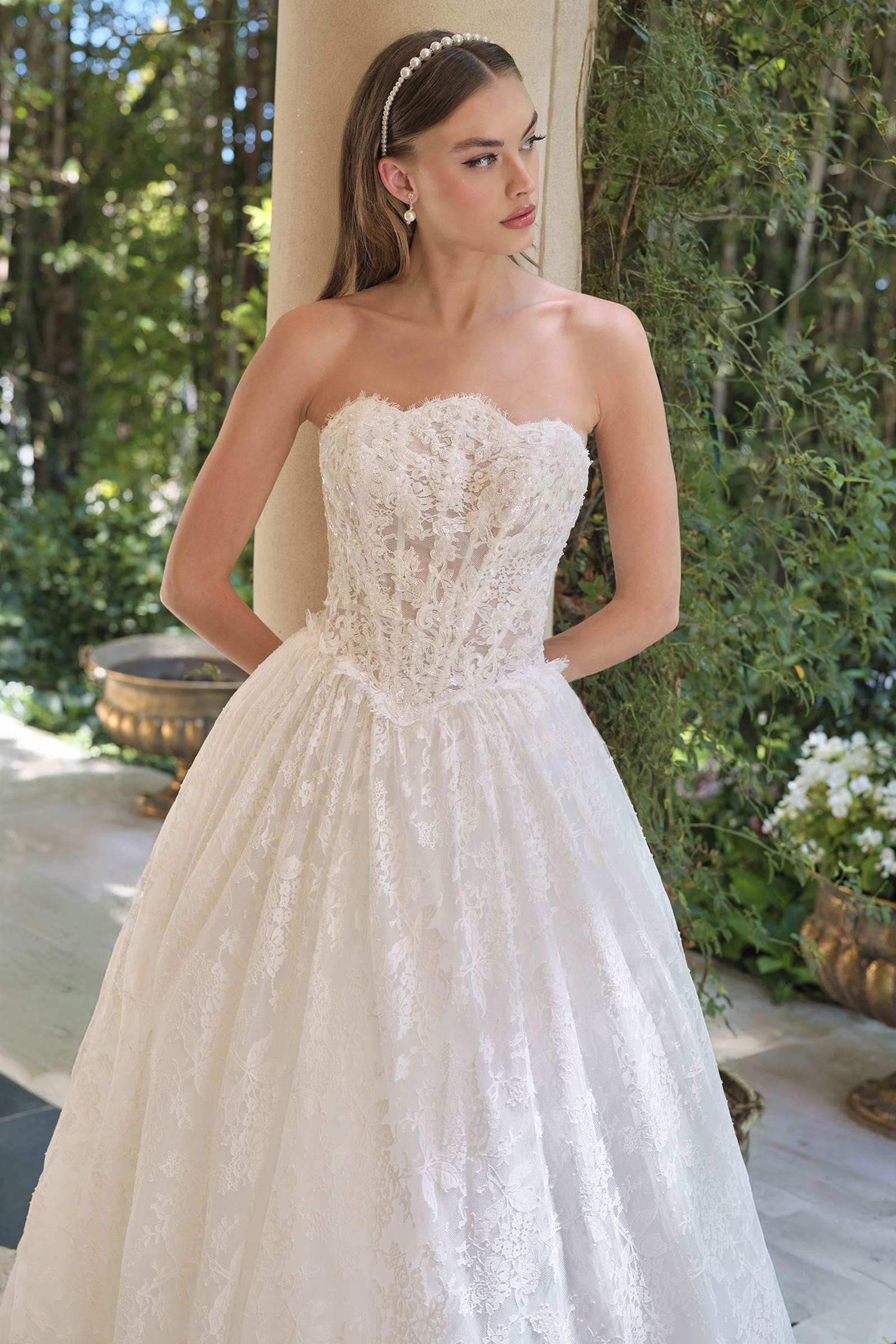 Off-white strapless lace A-line wedding gown with scalloped bodice and gathered waist