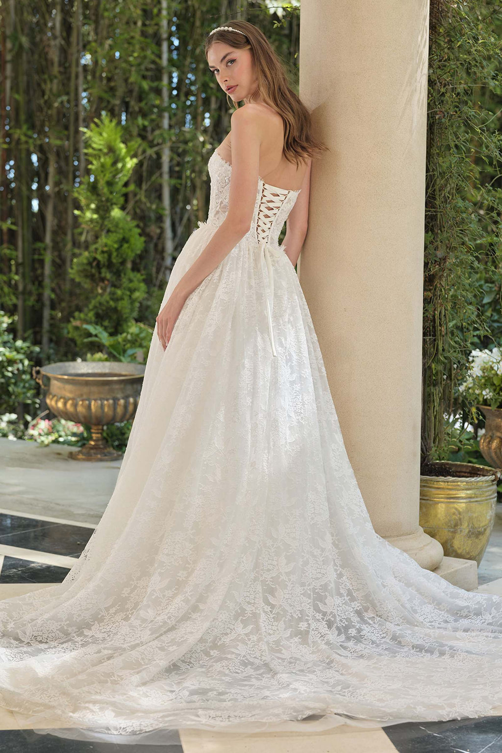 Off-white strapless A-line wedding gown with lace corset back and flowing skirt