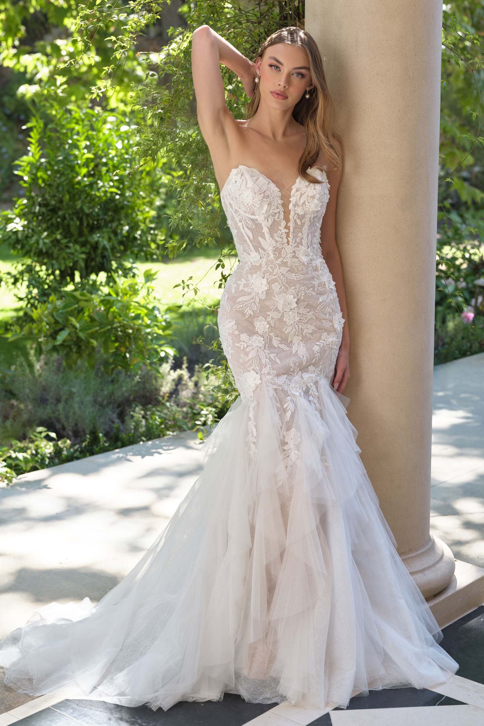 Strapless lace wedding gown with tulle overskirt and veil trailing behind