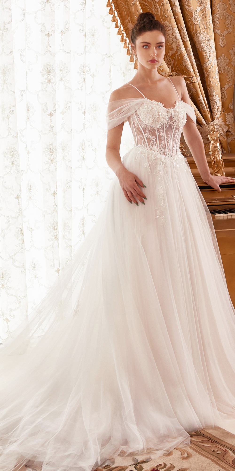 Off-white layered tulle A-line bridal gown with corset bodice and off-shoulder sleeves