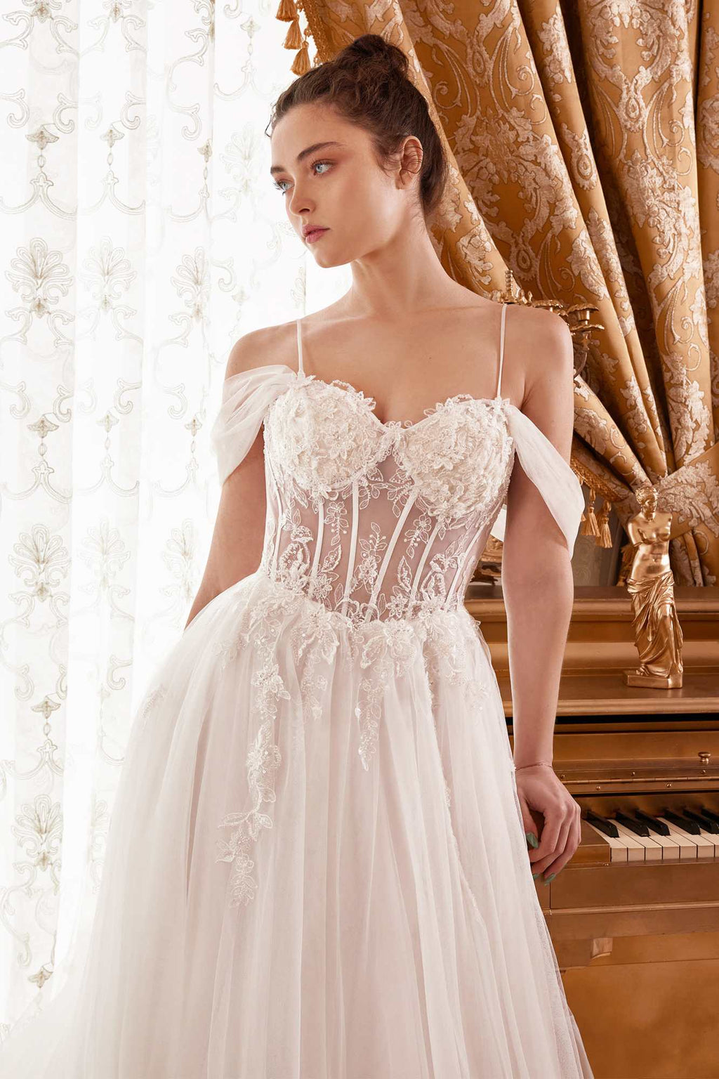 Off-white corset bodice A-line bridal gown with lace texture and thin spaghetti straps