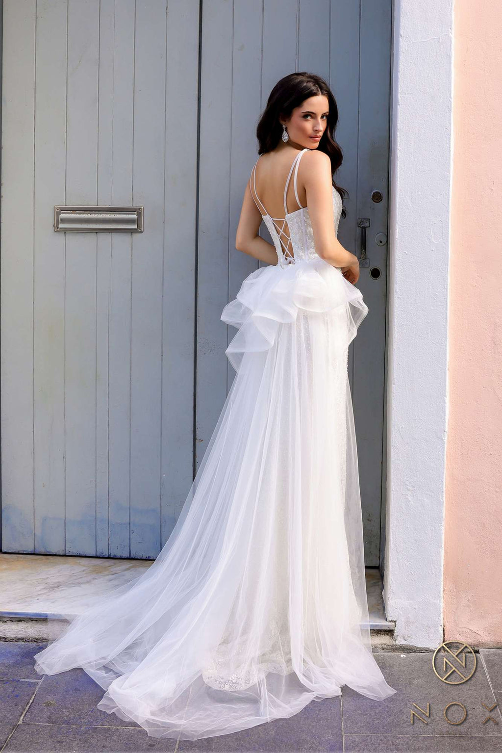 White sweetheart evening gown with fitted bodice, ruffled overskirt and long train