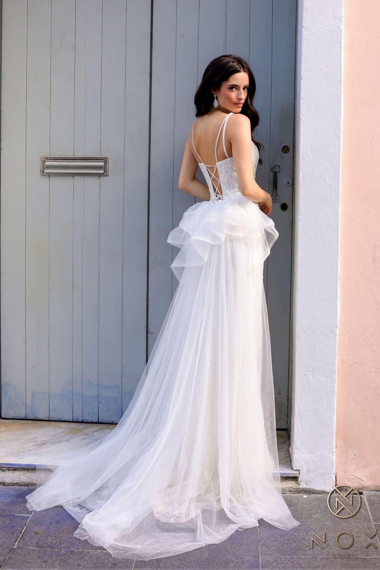 White sweetheart evening gown with fitted bodice, ruffled overskirt and long train