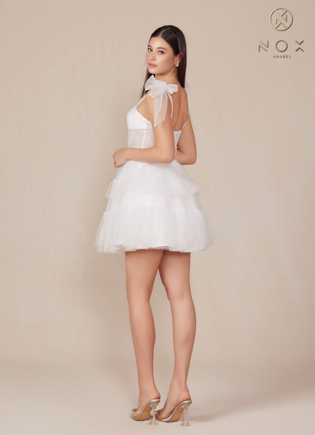 White A-line tulle dress with bow cap sleeves, sweetheart bodice, tiered ruffle skirt
