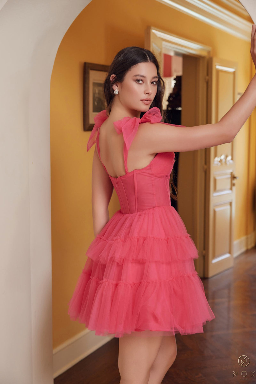 Fuchsia A-line tulle mini dress with ruffled tiers and bow straps, corset bodice (side)