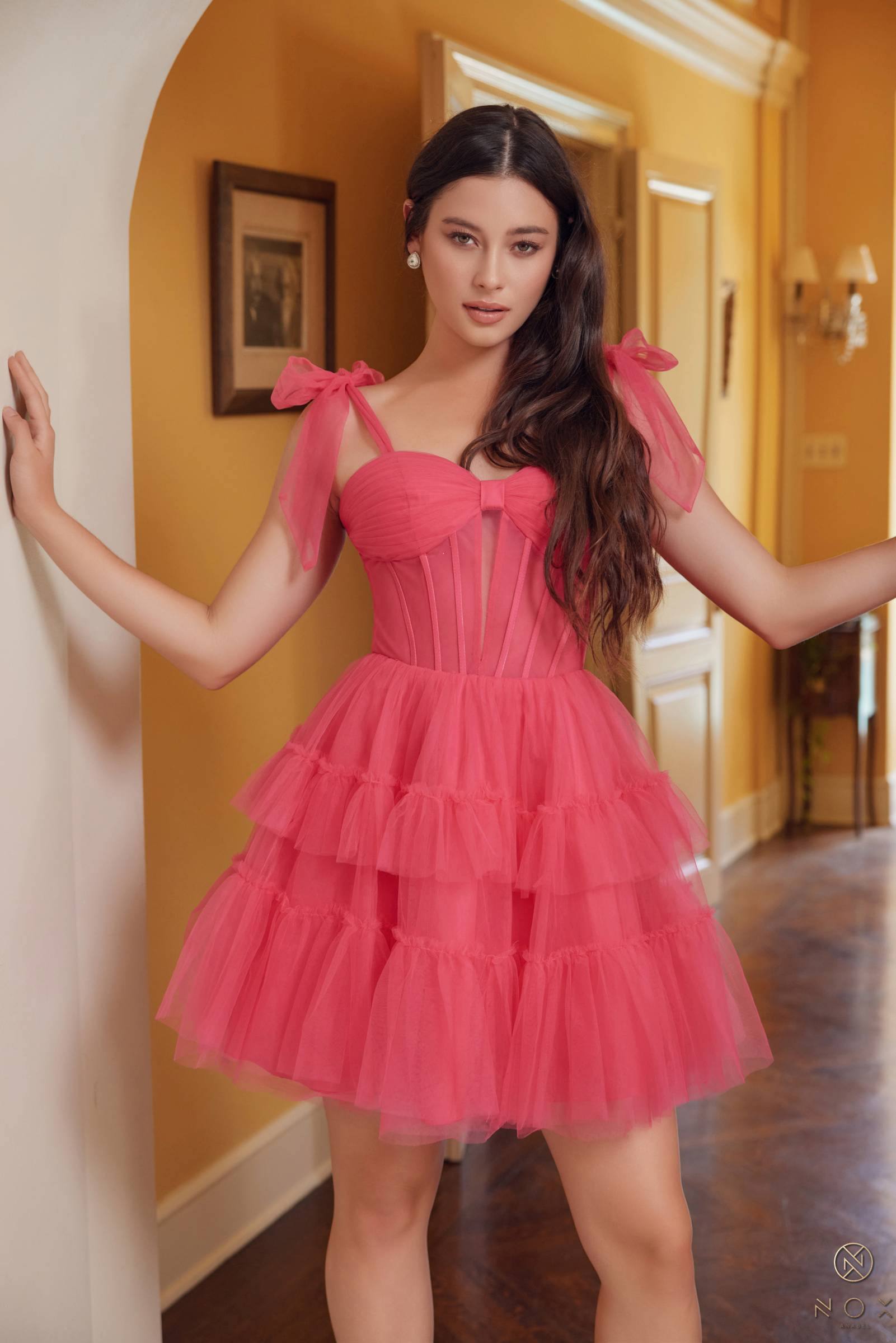 Fuchsia A-line tulle mini dress with ruffled tiers and bow straps, corset bodice