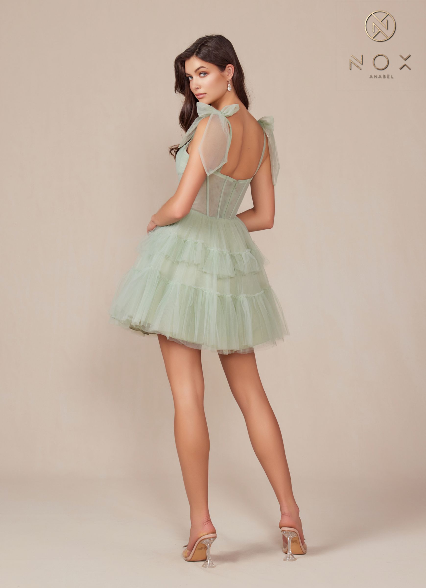 Sage green A-line tulle dress with tiered ruffle skirt, sleeveless design