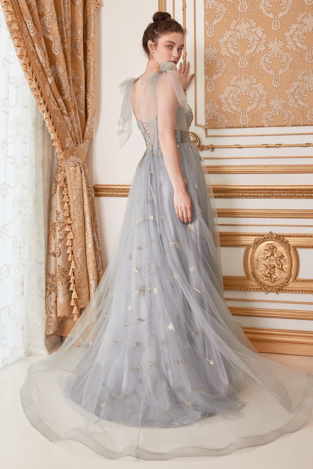 Embellished blue-gray long tulle gown with corset bodice and star motifs, open back straps.