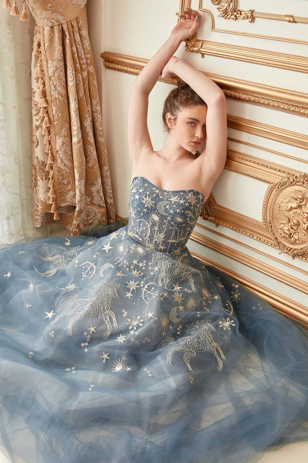 Blue strapless long tulle dress with glitter stars and gathered corset-style bodice