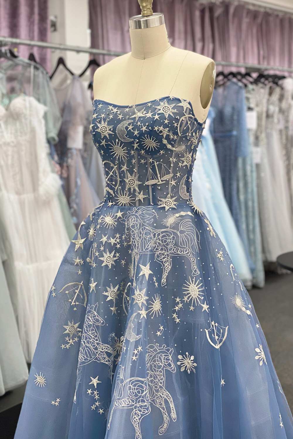 Strapless long dress with dark blue sheer overlay and starry constellation pattern, corset bodice