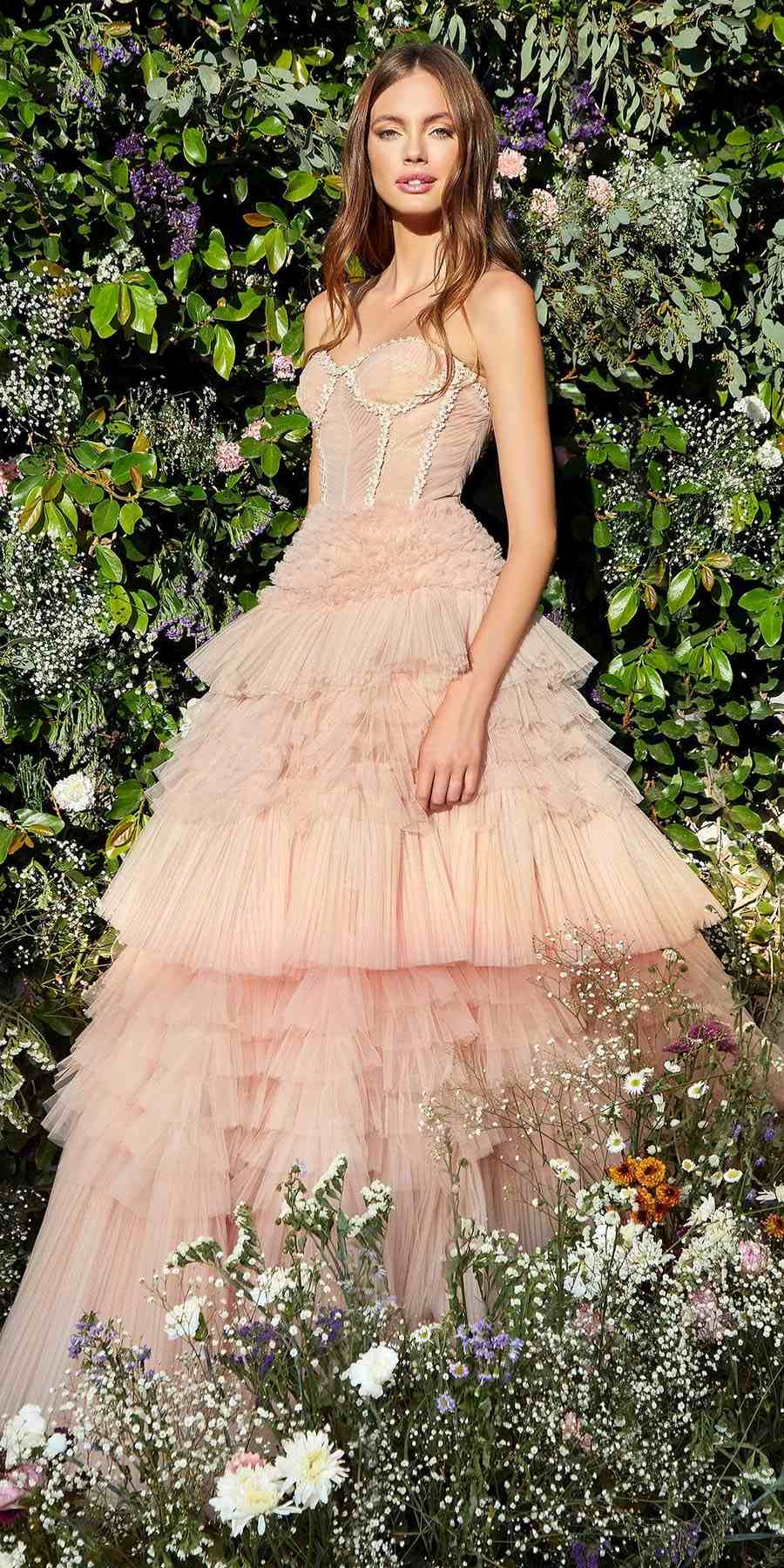 Blush pink tulle ball gown with embellished corset bodice and tiered ruffle skirt