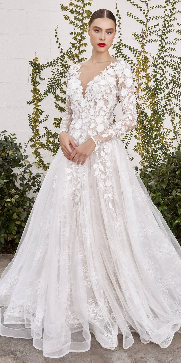 Off-white lace wedding gown with sweetheart neckline, long sleeves, and full tulle skirt