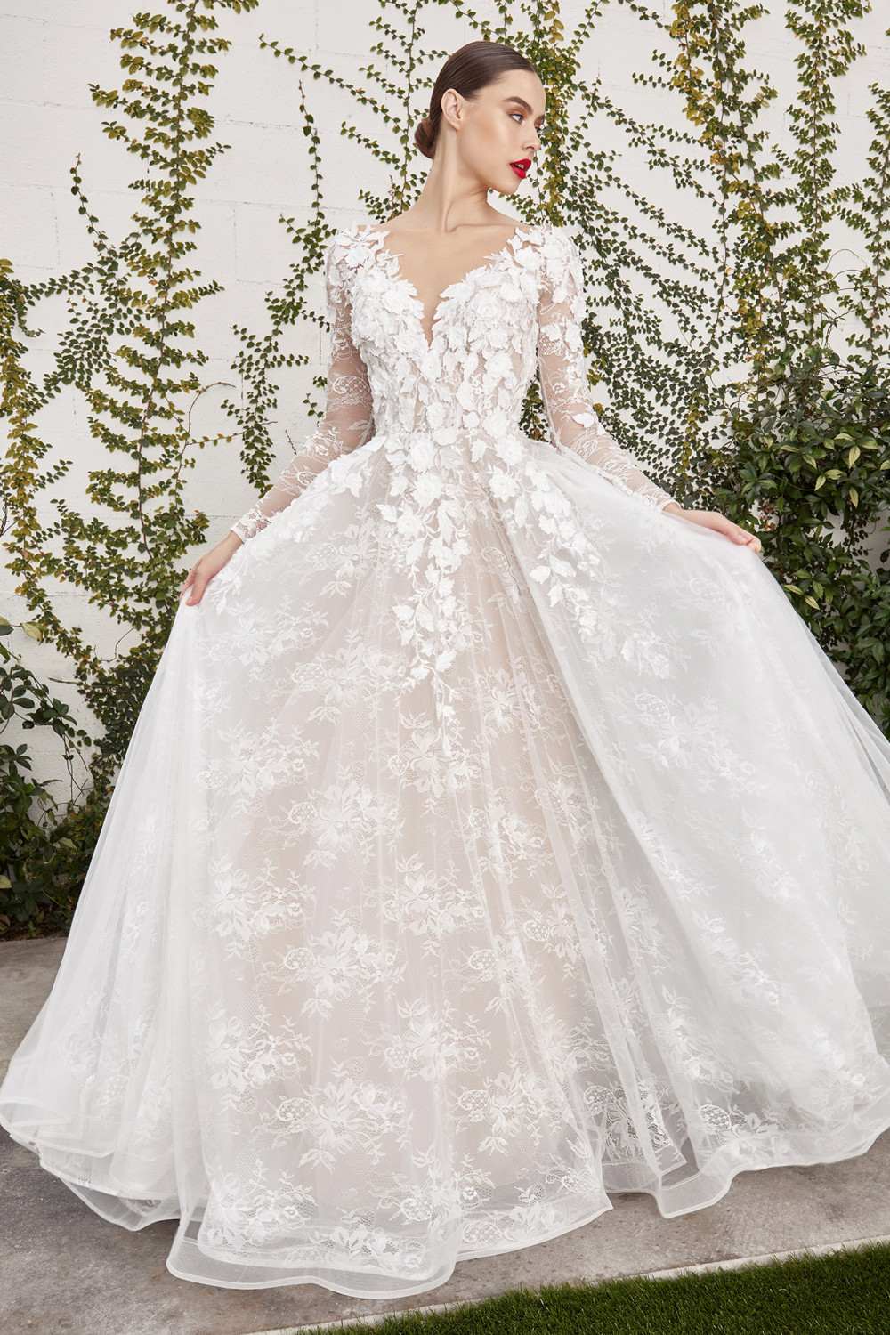 Off-white lace wedding gown with long sleeves, illusion back, and full A-line skirt