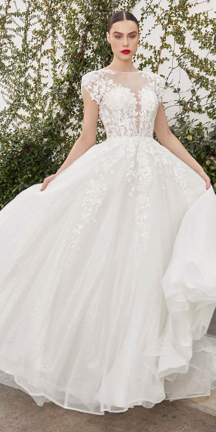 Off-white bridal gown with lace cap sleeves and fitted bodice, full A-line skirt