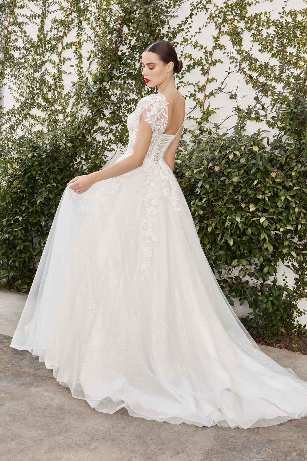 Off-white bridal gown, lace sleeves and illusion bodice with flowing A-line skirt