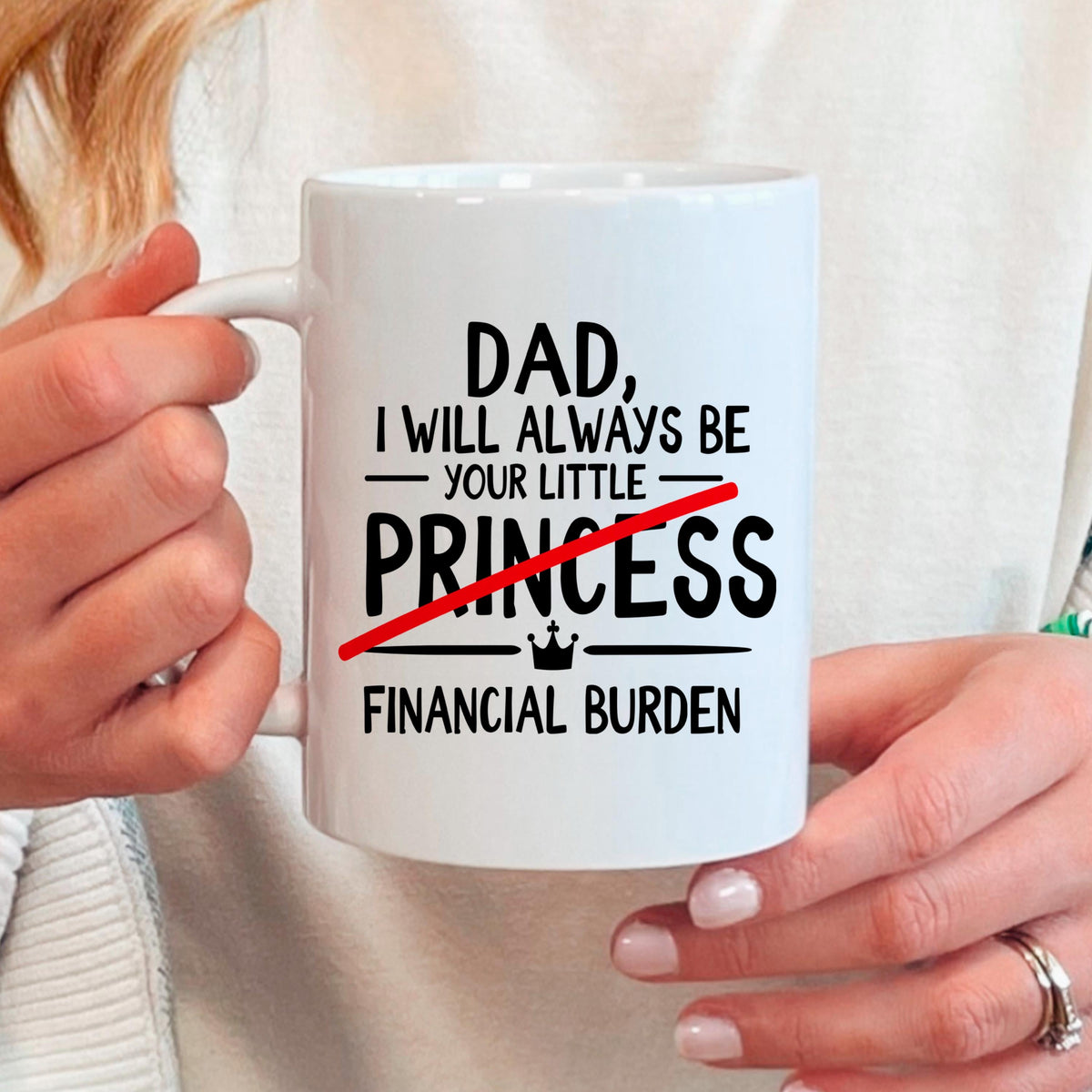 Hand holding white coffee mug with 'DAD' princess quote and 'FINANCIAL BURDEN' text