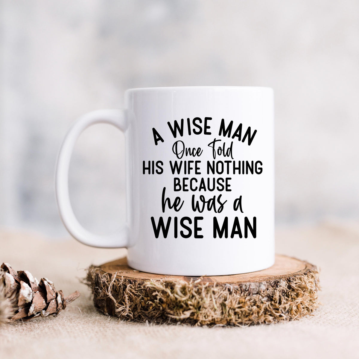 White ceramic coffee mug with "A WISE MAN" quote, centered front design