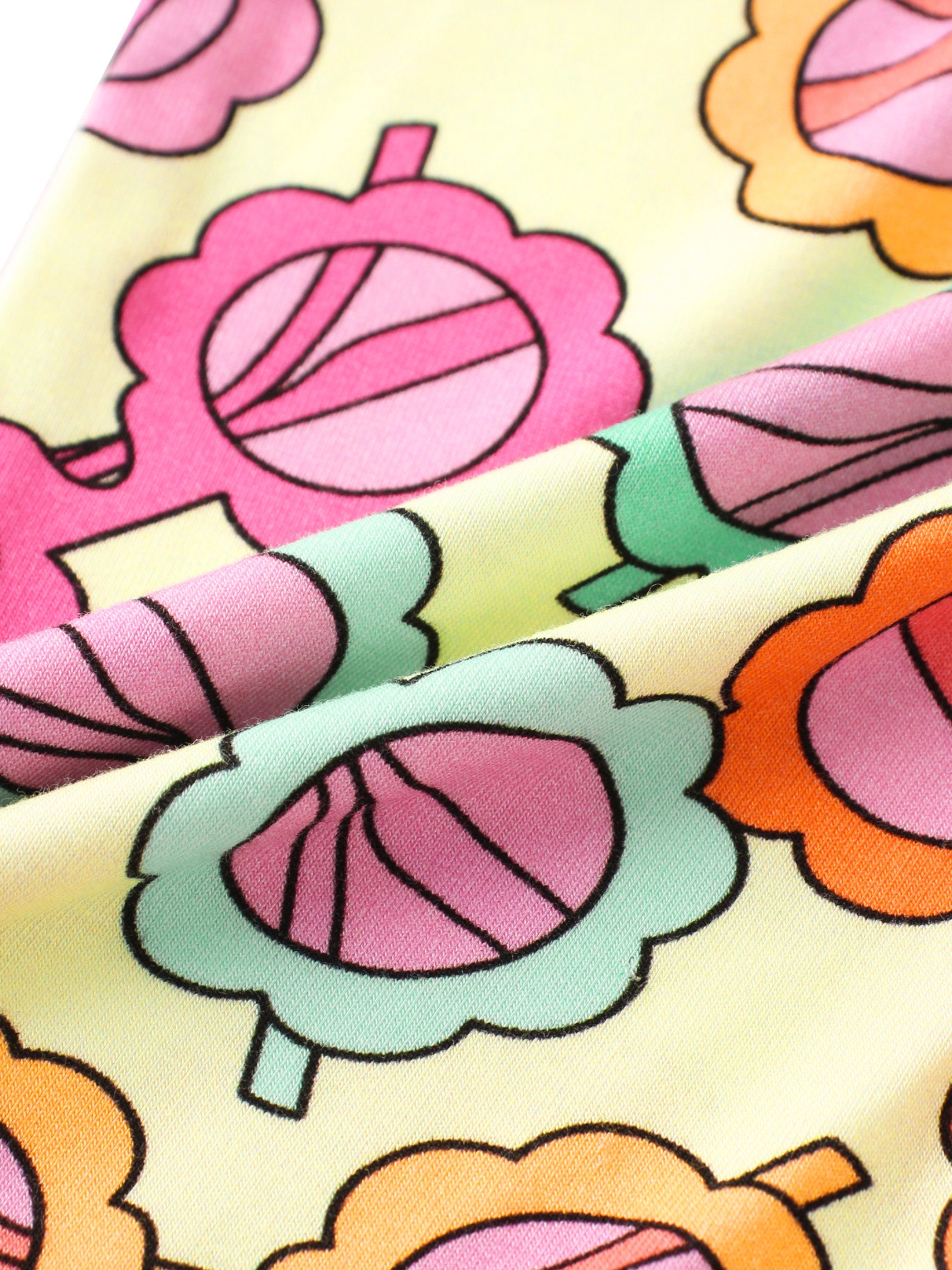 Baby romper fabric with pastel flower and leaf pattern on light yellow base