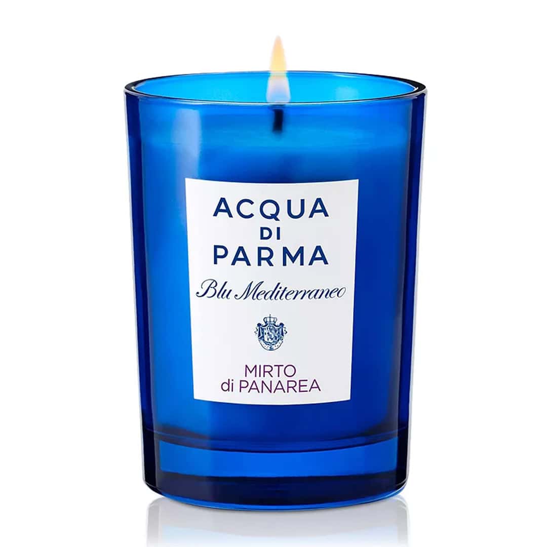 Acqua di Parma Mirto di Panarea candle in blue glass jar with label and flame