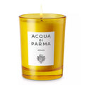Amber scented candle in clear glass with branded label and lit wick