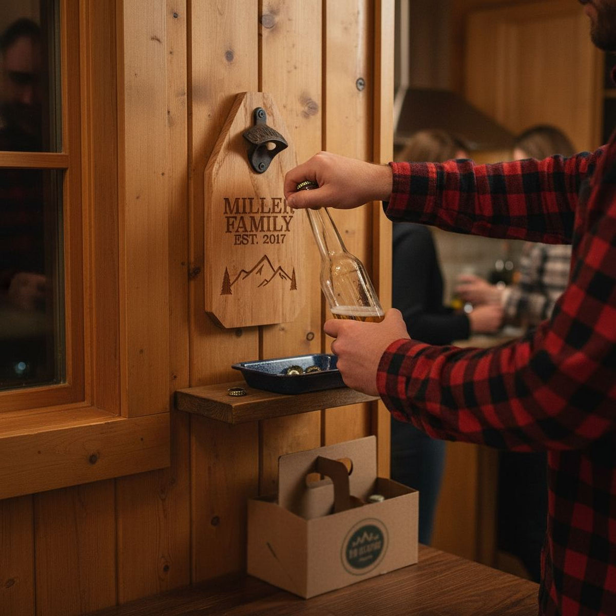 Wood bottle opener sign on a cabin wall with engraved family name; a hand places a bottle
