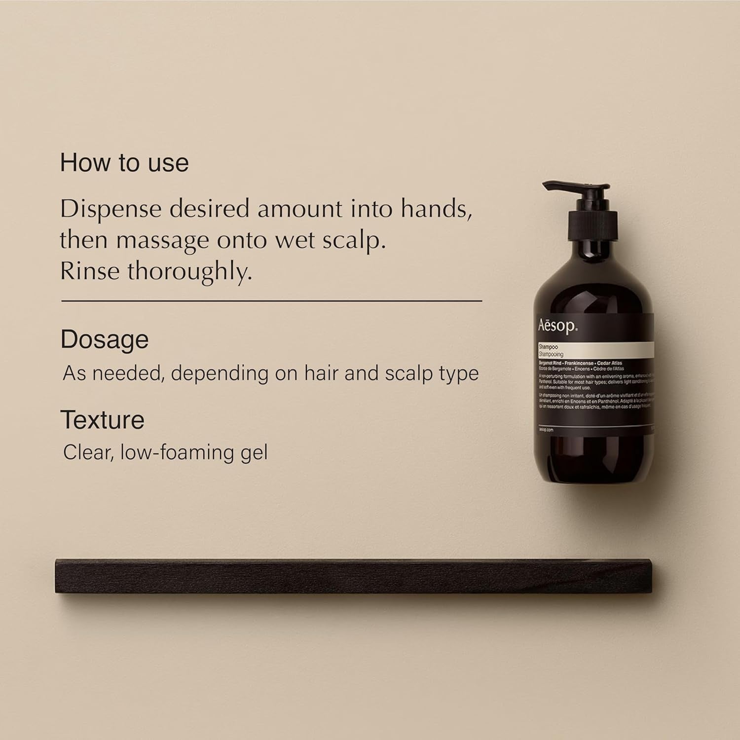 Aesop shampoo pump bottle with dark label and amber liquid