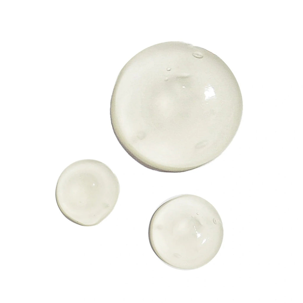 Cream swatches in three round dots, thick glossy texture