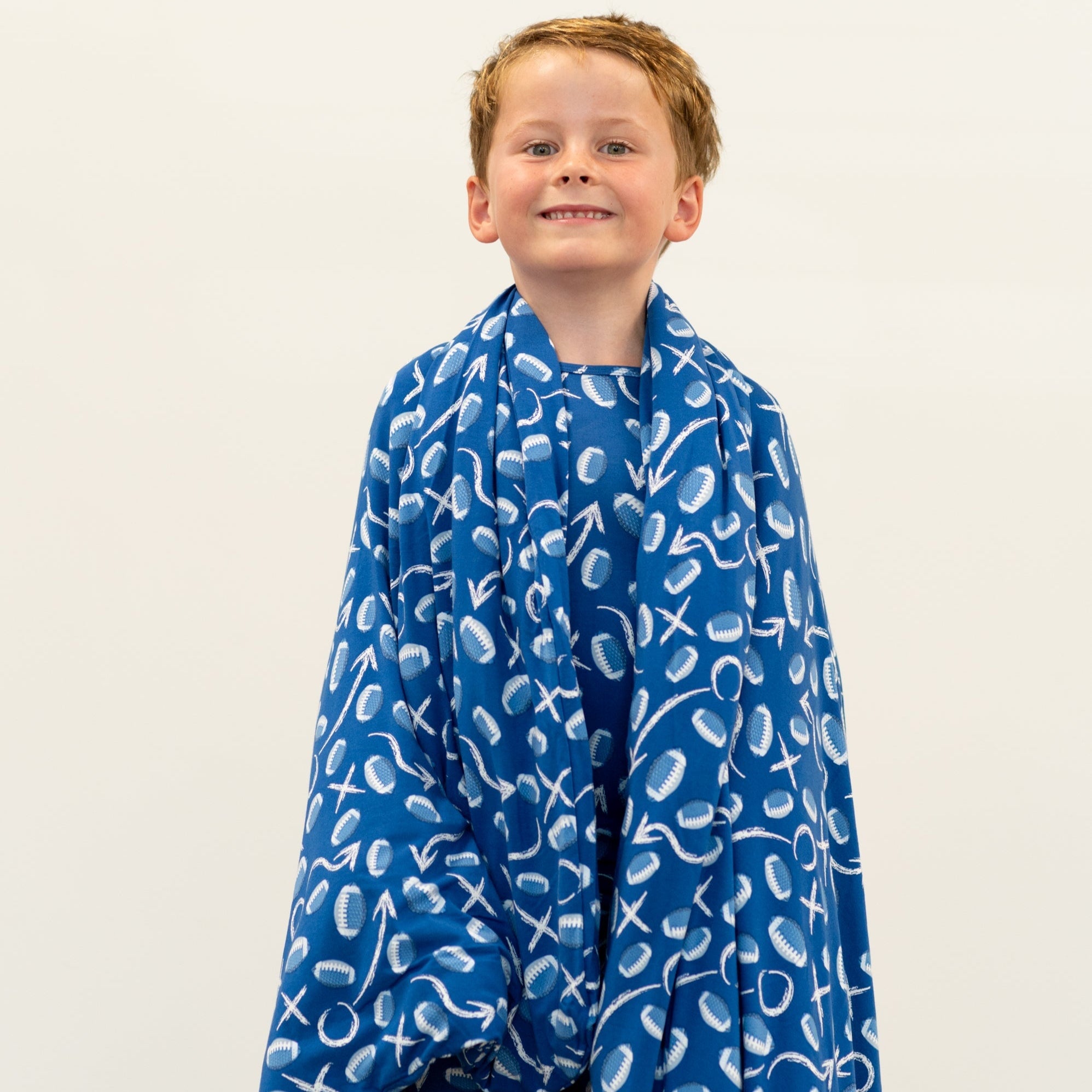 Kids blue patterned blanket cape style with boy smiling in front view