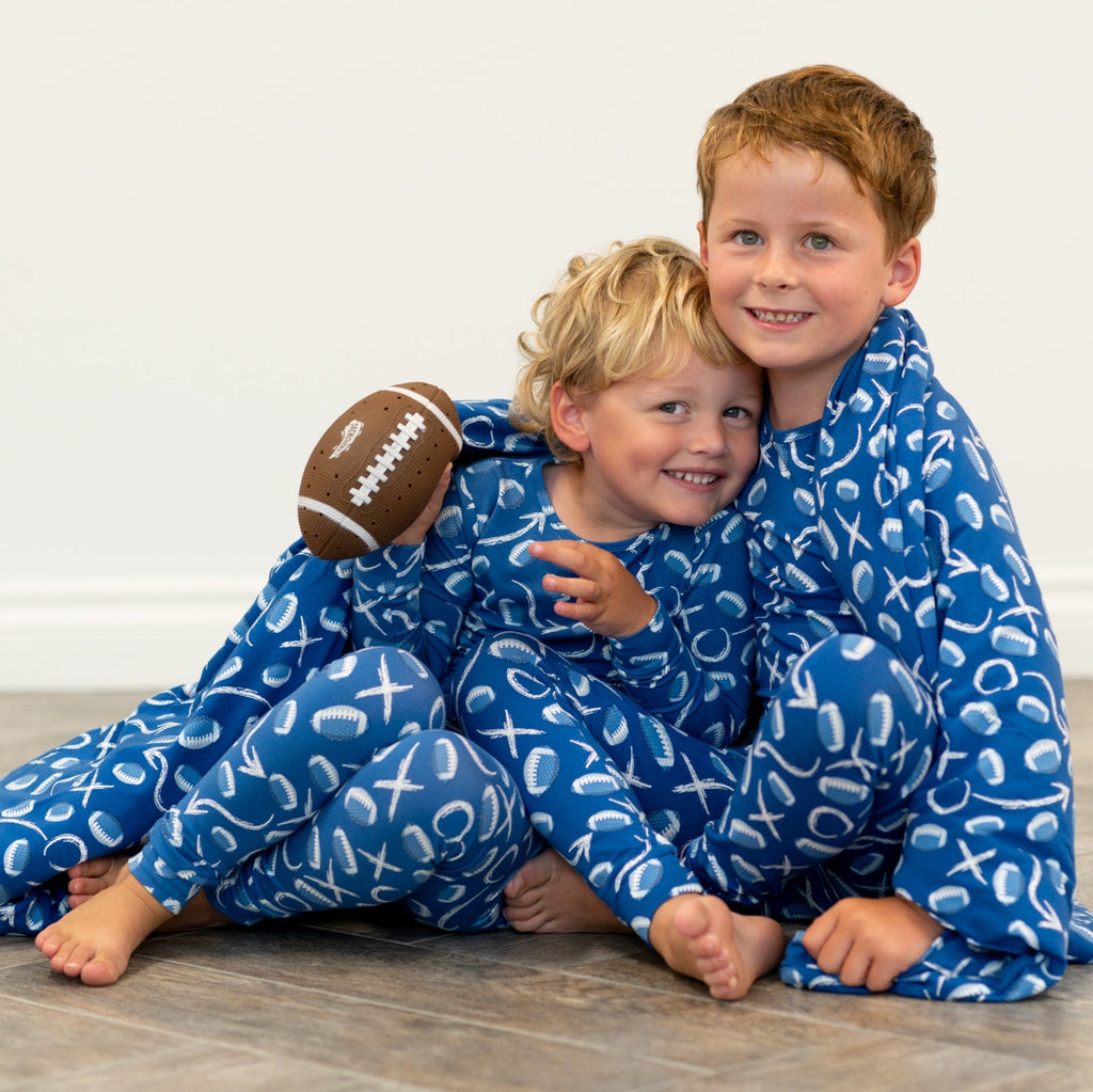 Blue kids pajama set with long sleeves and pants, white icon print