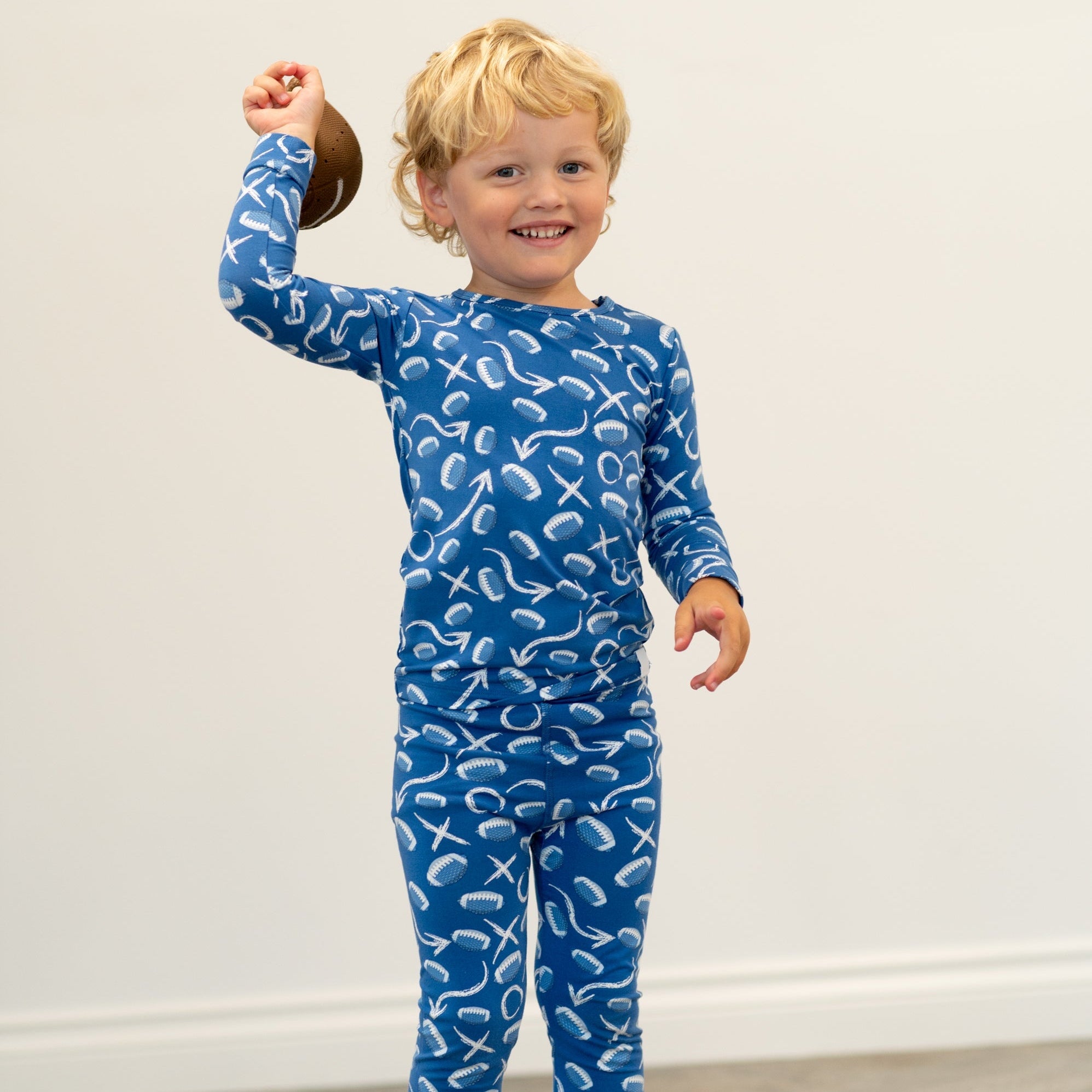 Blue kids pajama set with long sleeves and matching pants, white icon print