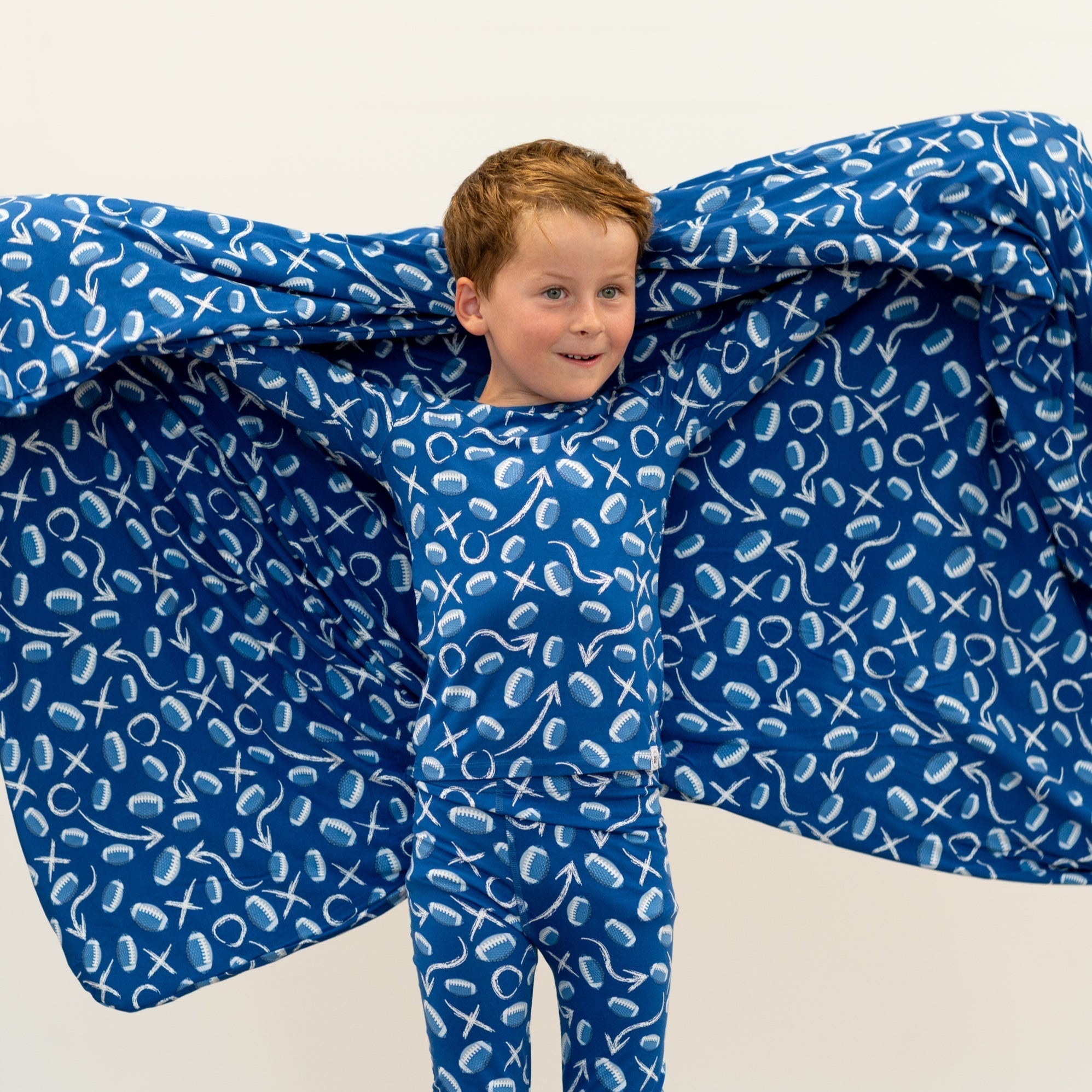 Blue kids pajama set with long sleeves and pants, white icon print