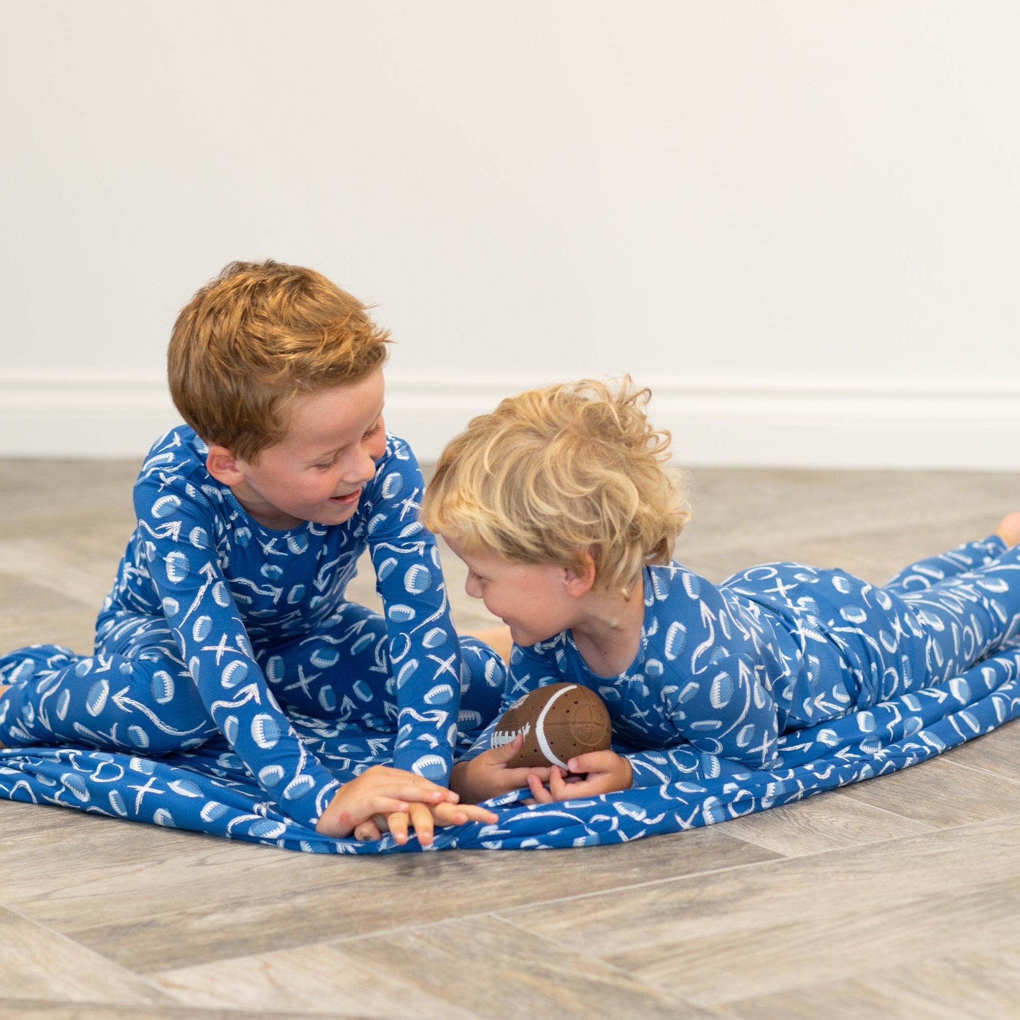Blue kids pajama set with long sleeves and pants, white icon print