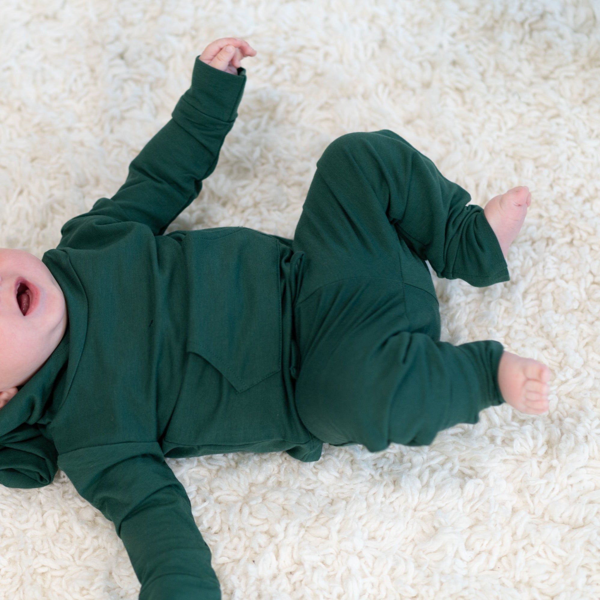 Alpine green hooded jogger set on child, hoodie and jogger pants laid out.